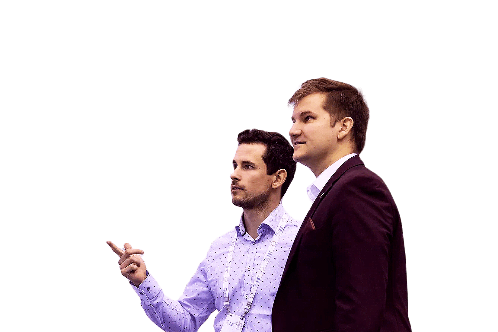 Two men talking and looking at something. One is pointing.
