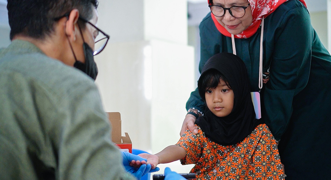 Young girl getting her blood glucose tested