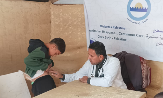 Doctor providing care to a child with diabetes at a Diabetes Palestine clinic